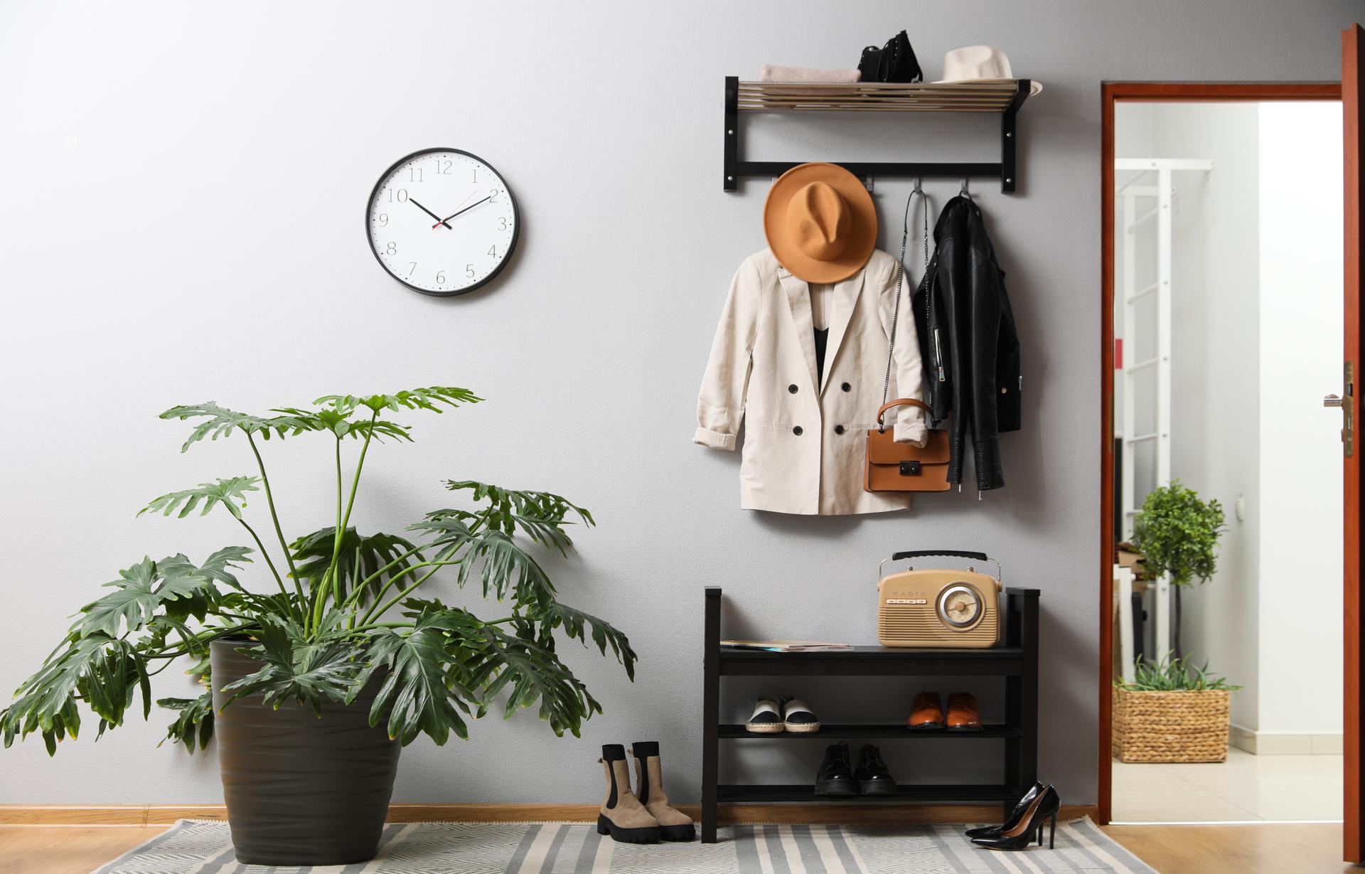 Hallway interior with stylish furniture, clothes and accessories